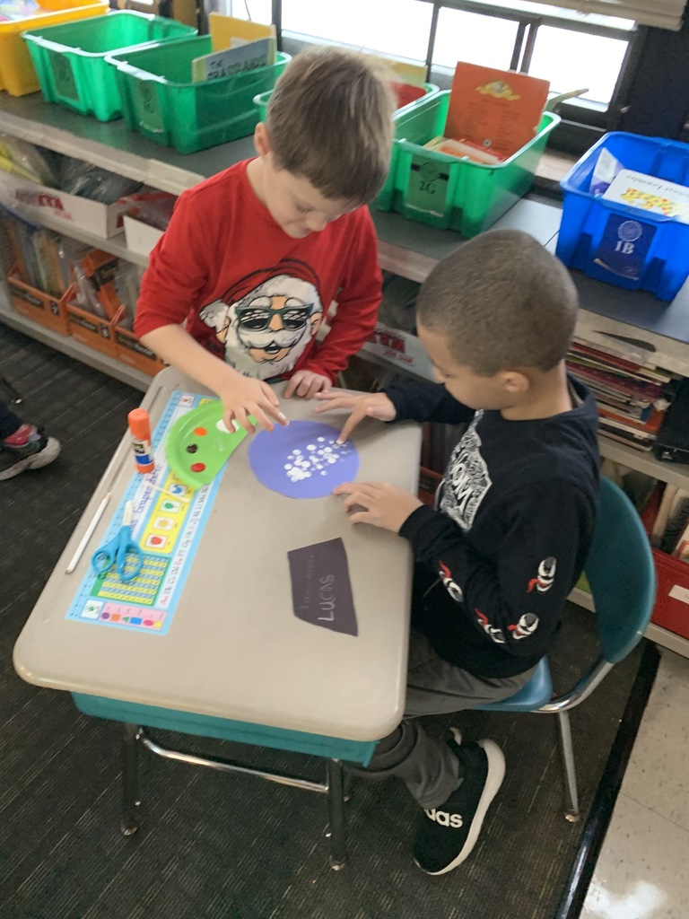 students working on paper snowglobe