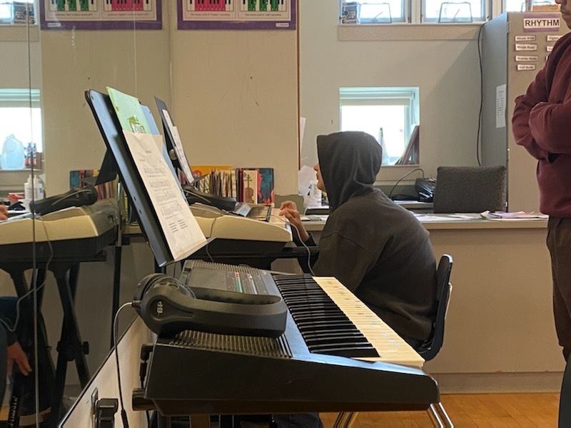 kid practicing keyboard