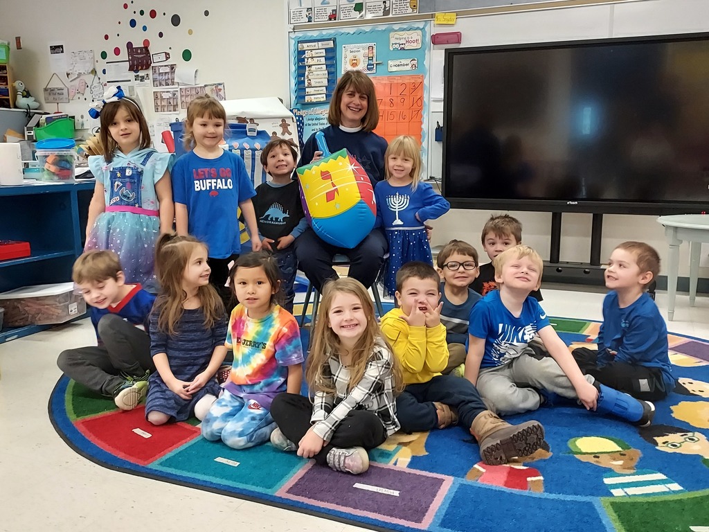 group of prek students pose with hanukkah items