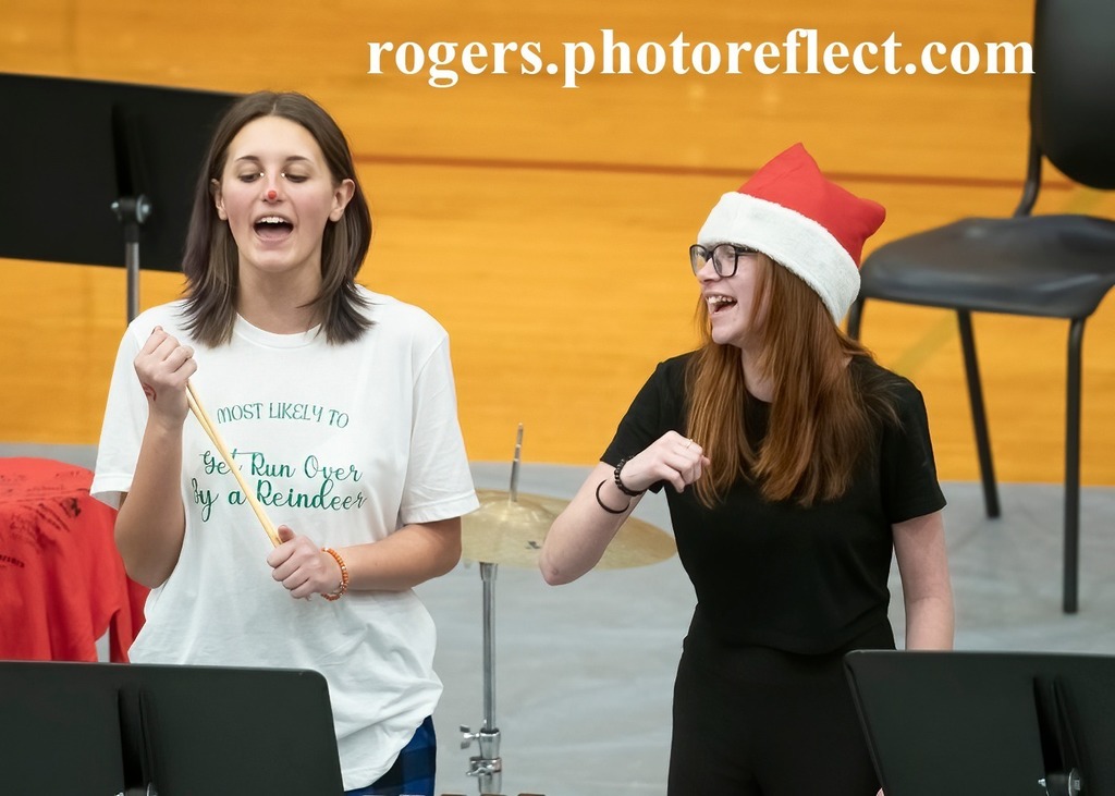 Two girls laugh during band performance