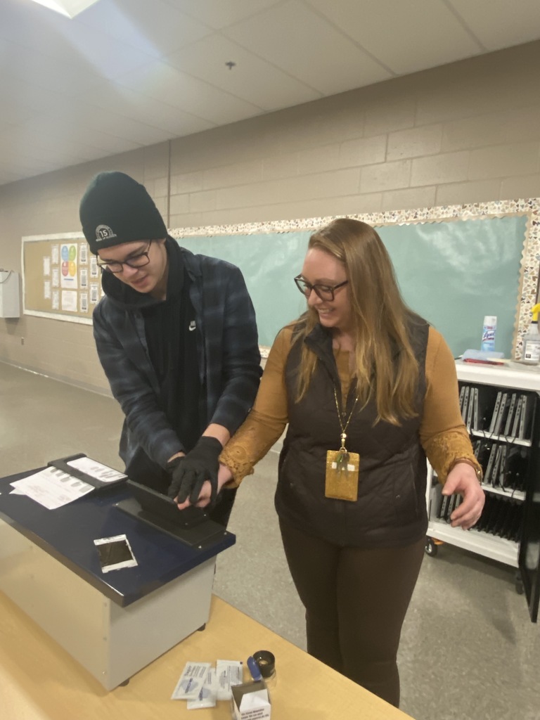 Teacher being fingerprinted by student