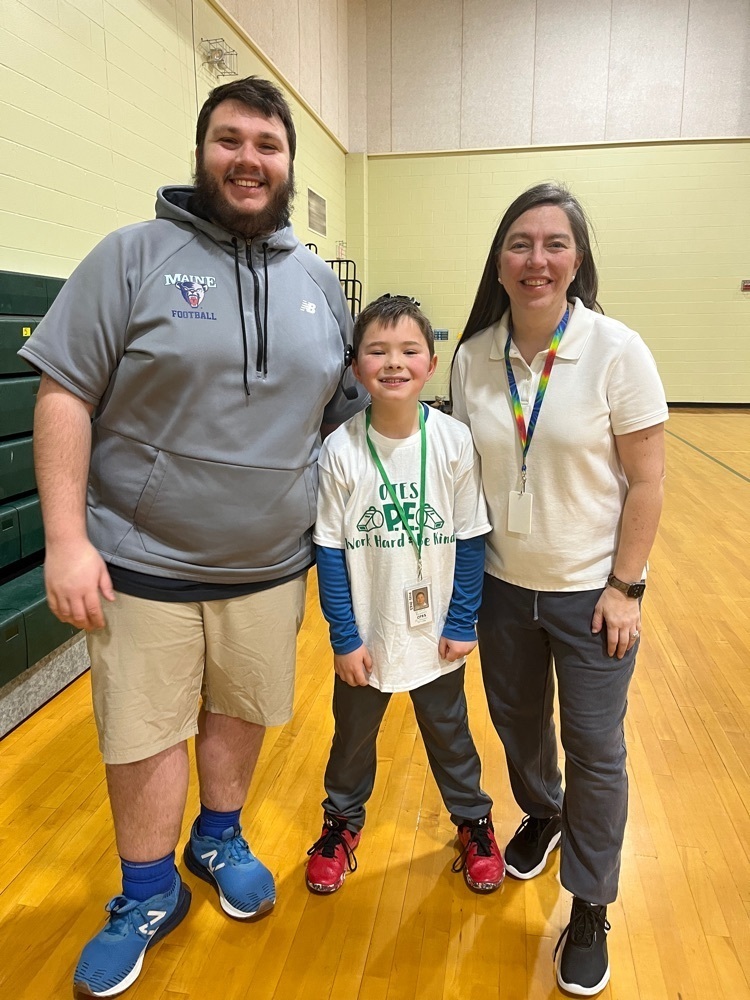 PE staff and student pose together 