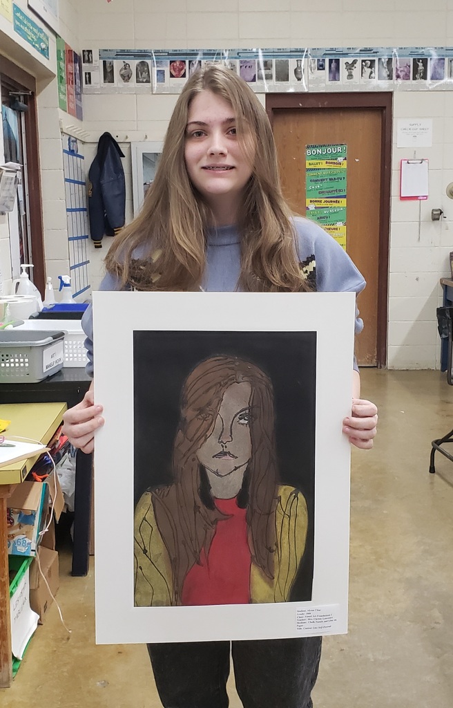 a high school girl holding her art project