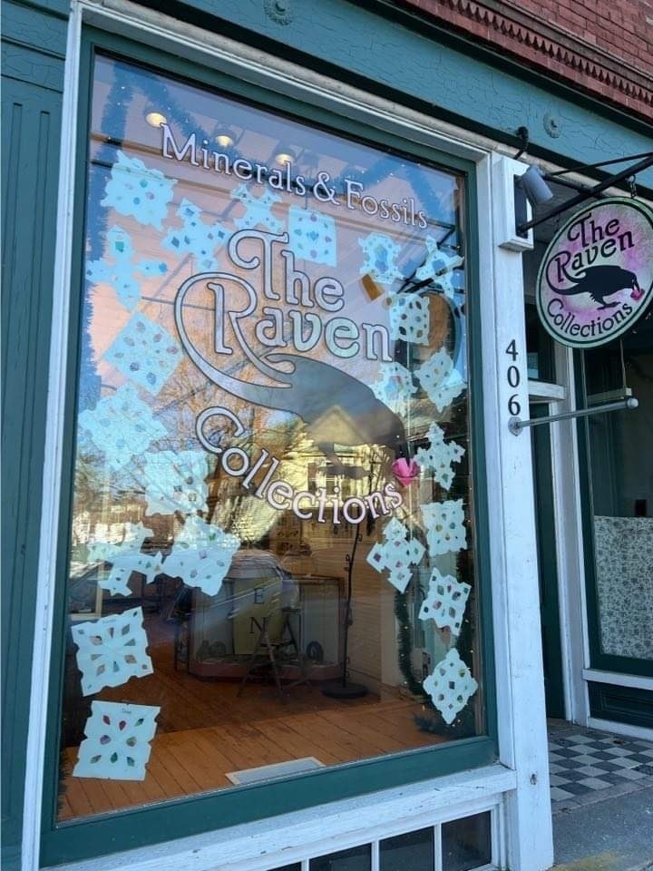 Student made snowflakes in the window at The Raven.