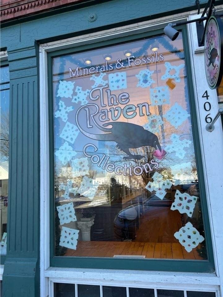 Student made snowflakes in the window at The Raven.