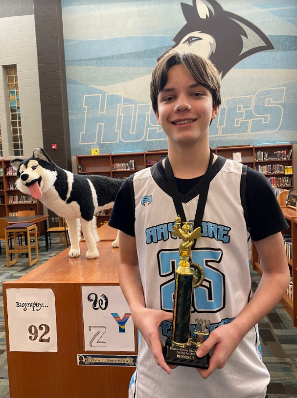 RPEMS 8th grader Kadyn Johnson with trophy from spelling bee