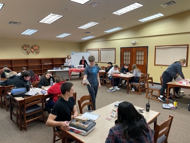 Students in Ms. Johnson's English class work with librarian , Heather Johnson, on a STEAM challenge as they prepare to read Fahrenheit 451!