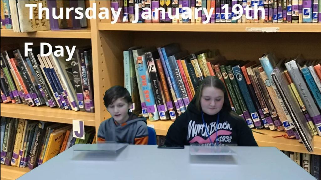 students at newsdesk with book shelves on green screen