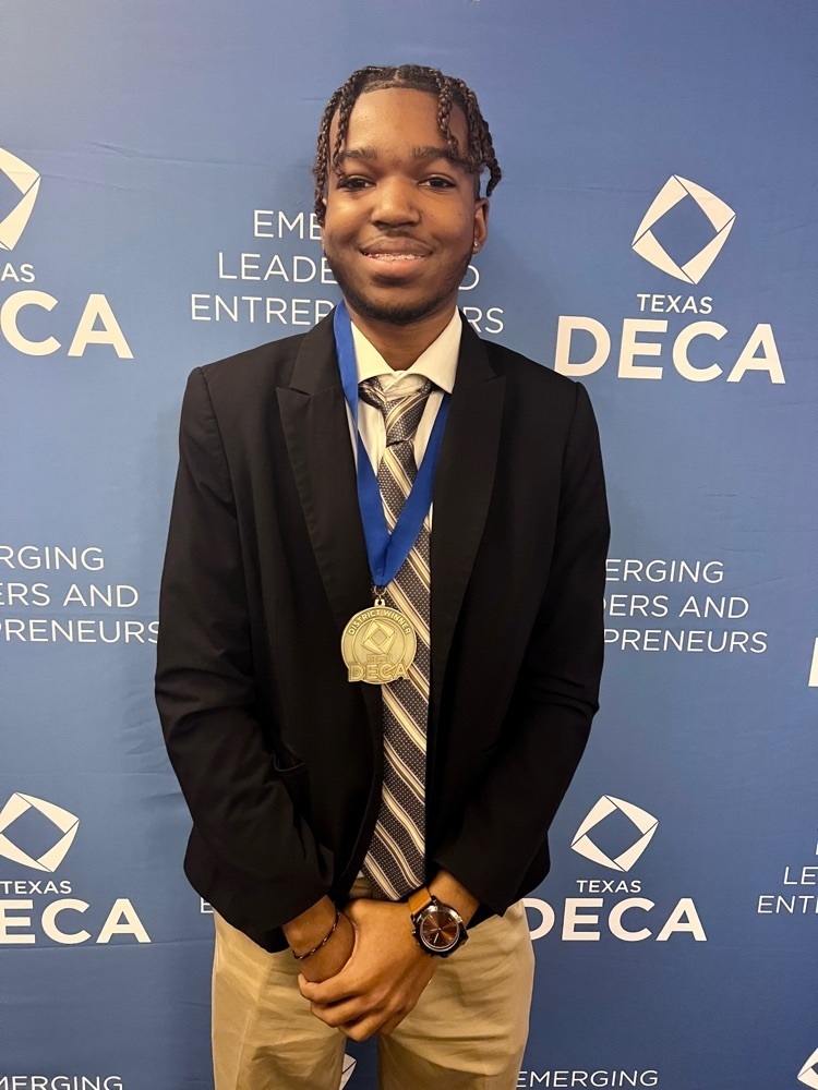 1 male student with medal. smiling. 