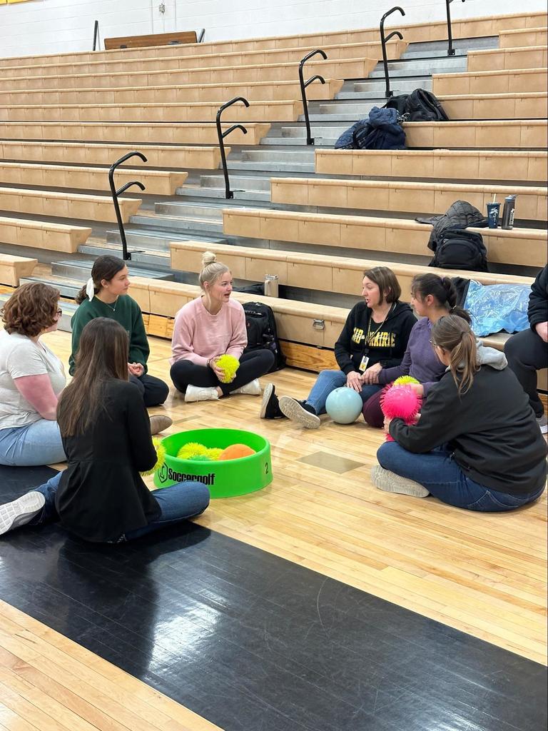 Students sitting in a circle to play a game