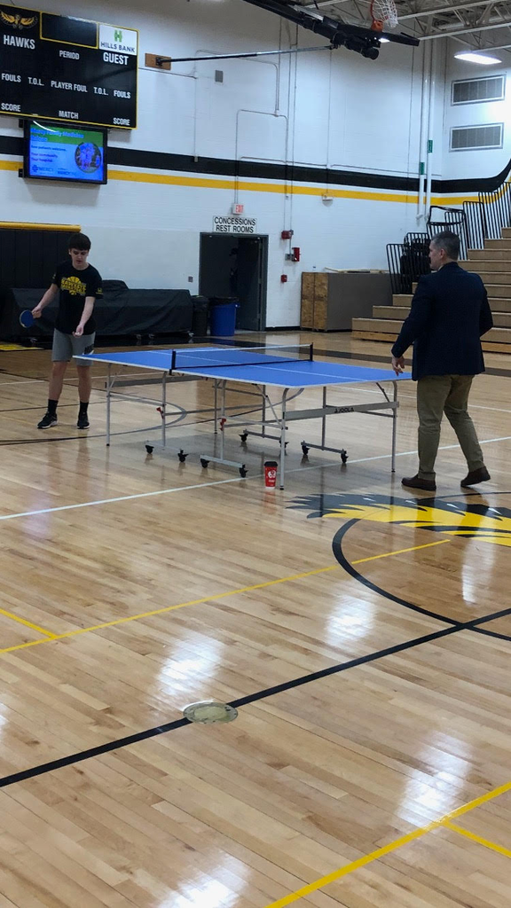 Brian Stone playing ping pong with a student