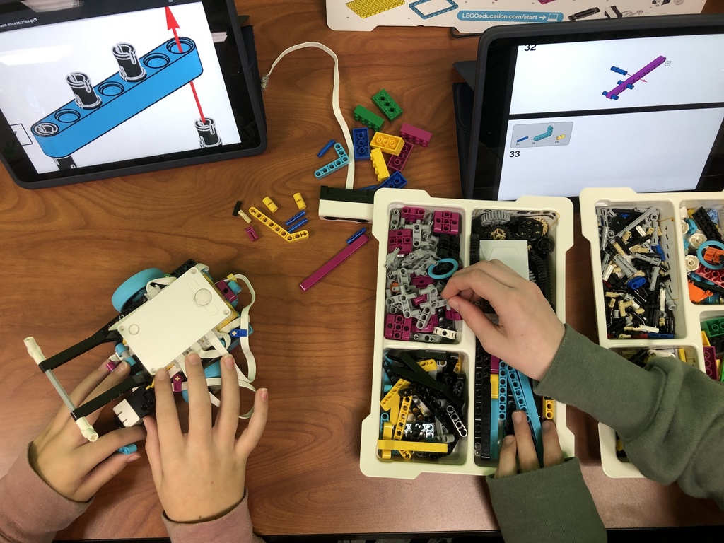 hands building lego robot