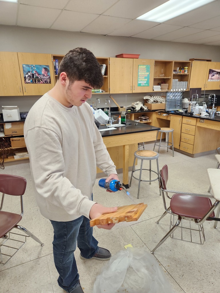 Seth melting the excess wax off the panel tabs for easier attachment