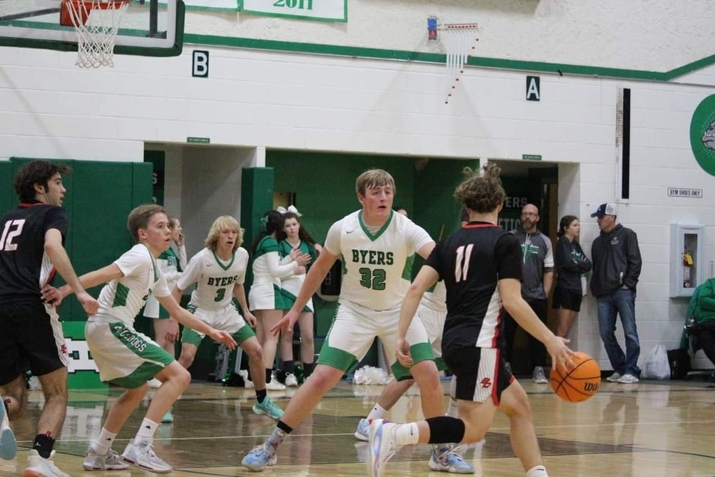 multiple basketball players playing defense