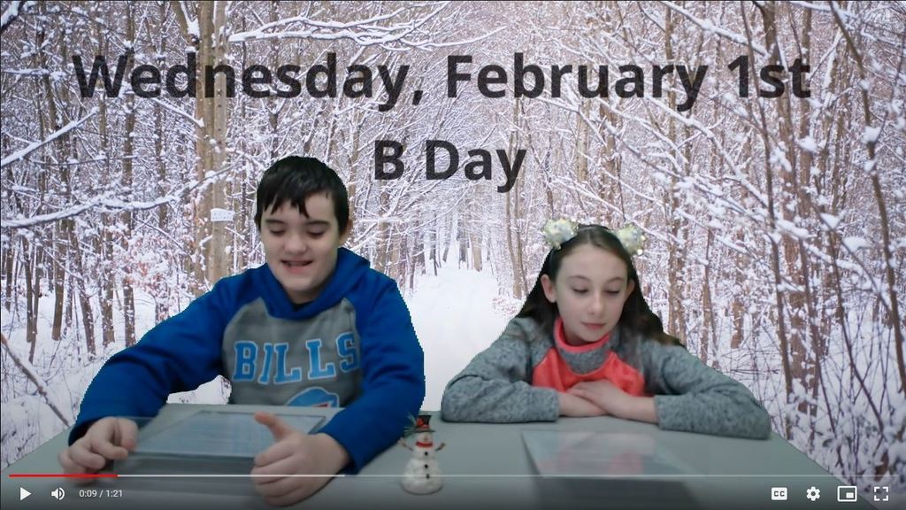 two students at news desk with snowy tree lined path on green screen