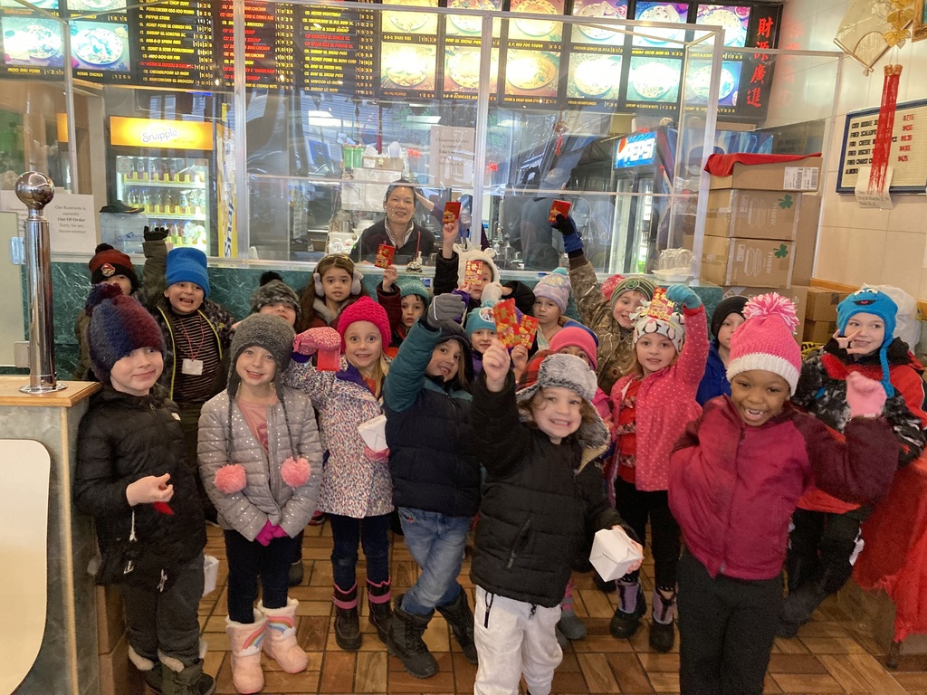 Students stand in front of a counter at a Chinese food restaurant.