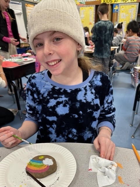 fifth grade student painting kindness rock