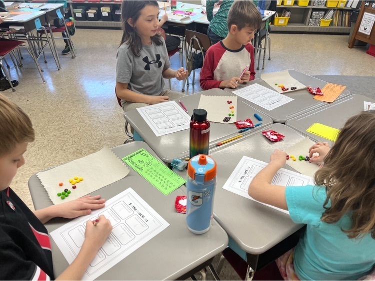 kids with Skittles doing fraction work