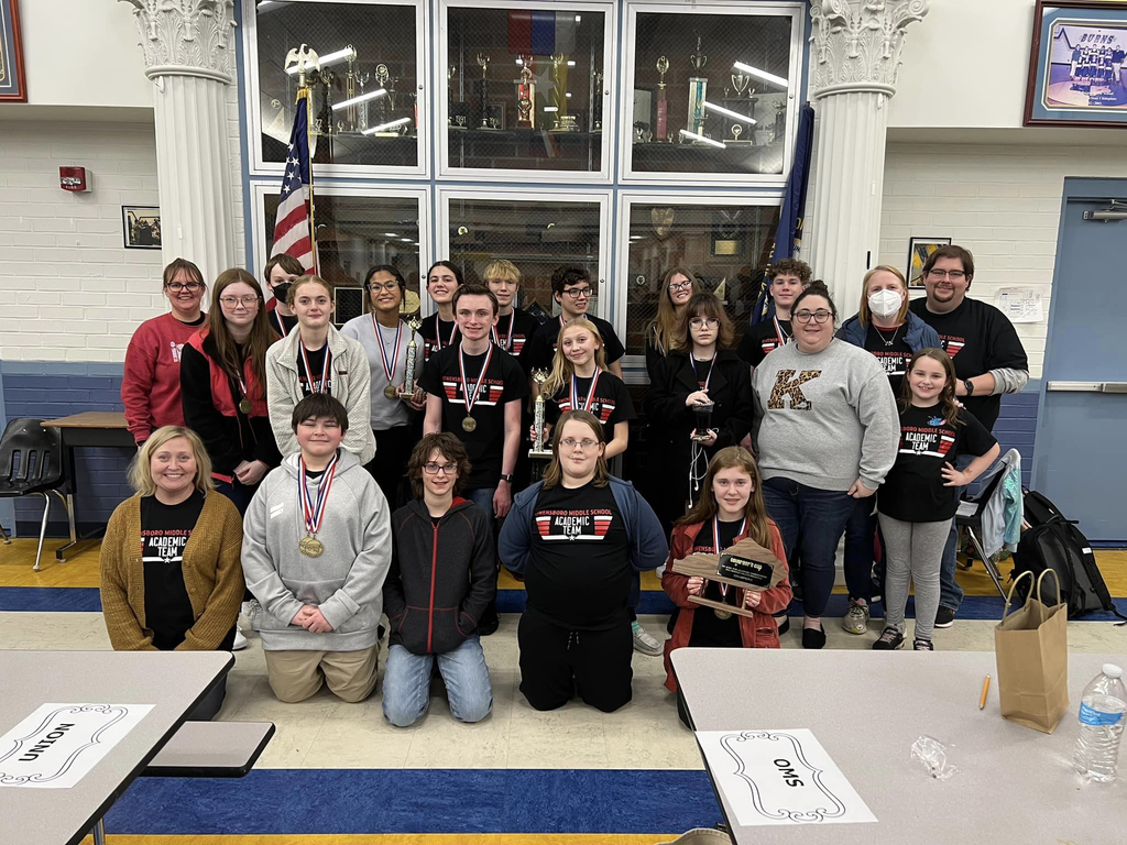 Photo of academic team with trophy and medals