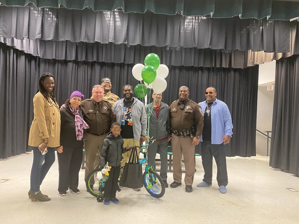 student with bicycle, family, Sheriff's deputies and balloons