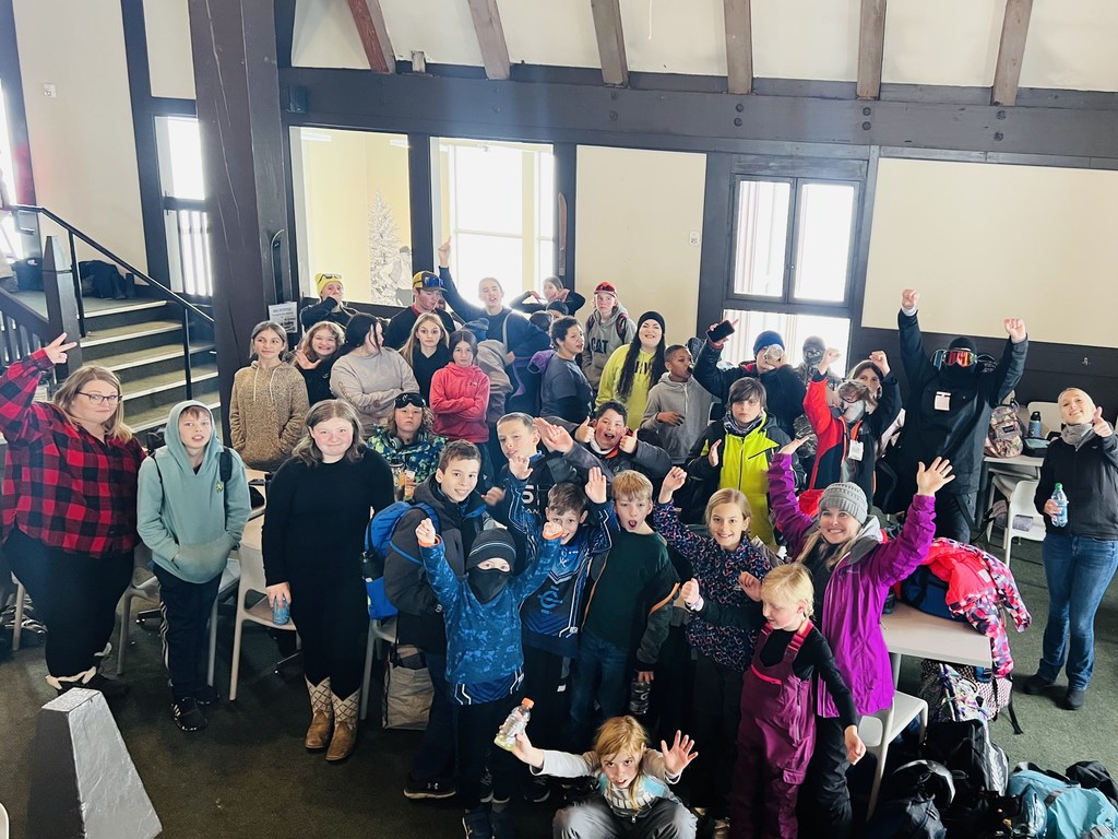 students in snow gear at ski lodge