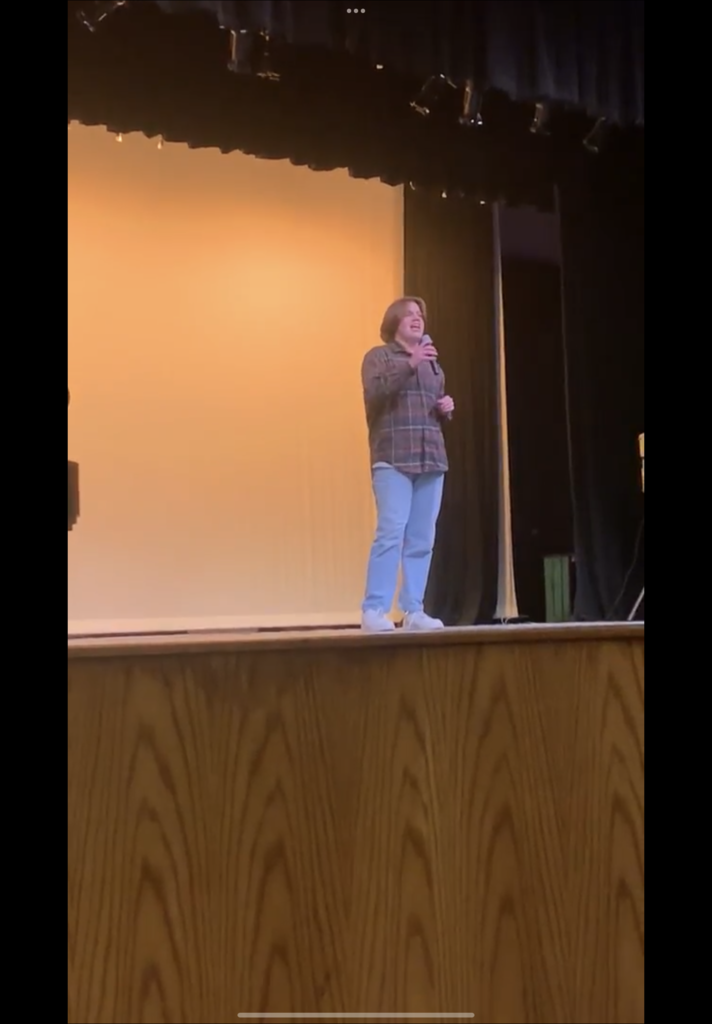 Jakob Cruze on Legacy theater stage singing during the Black History Month celebration