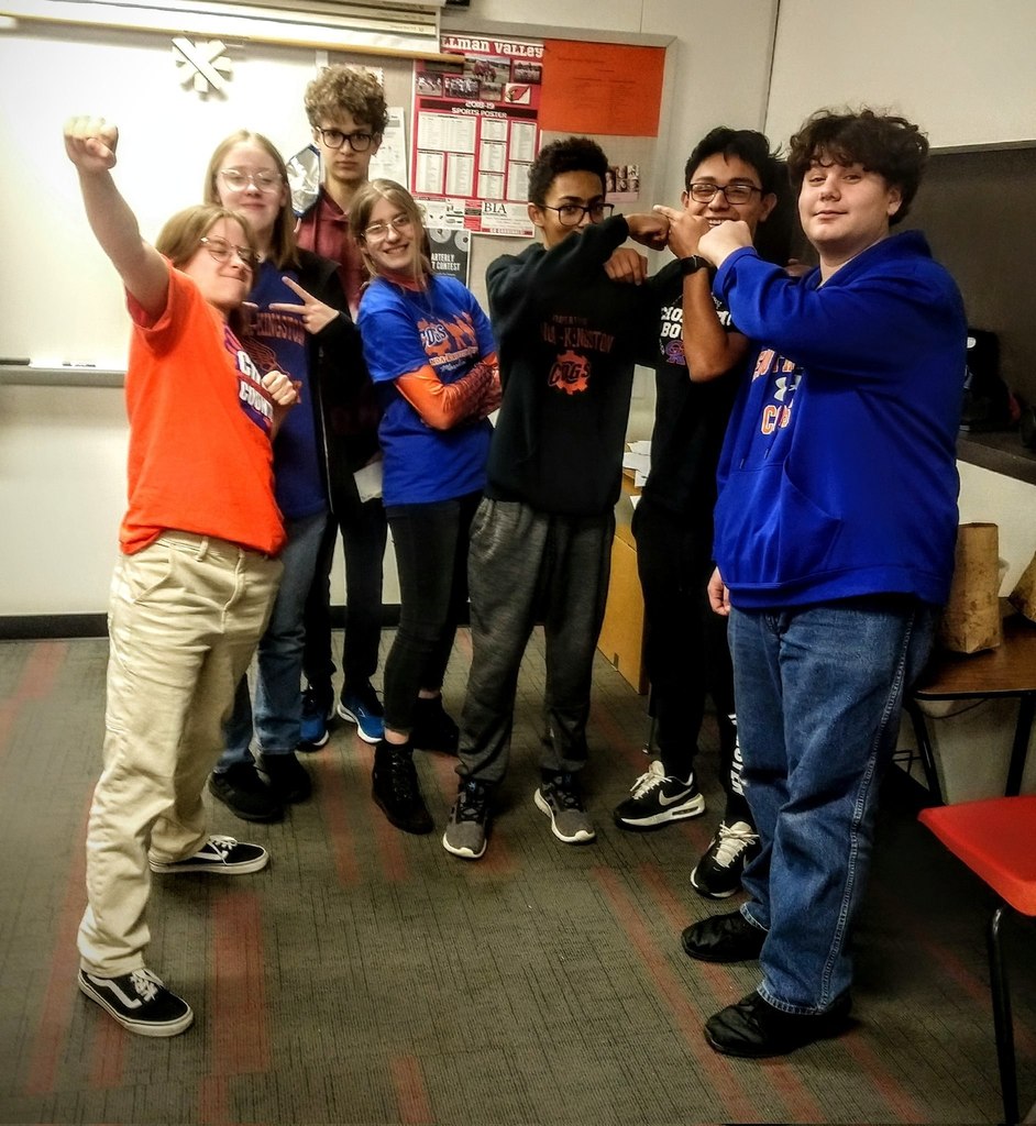 cross country students smile in classroom