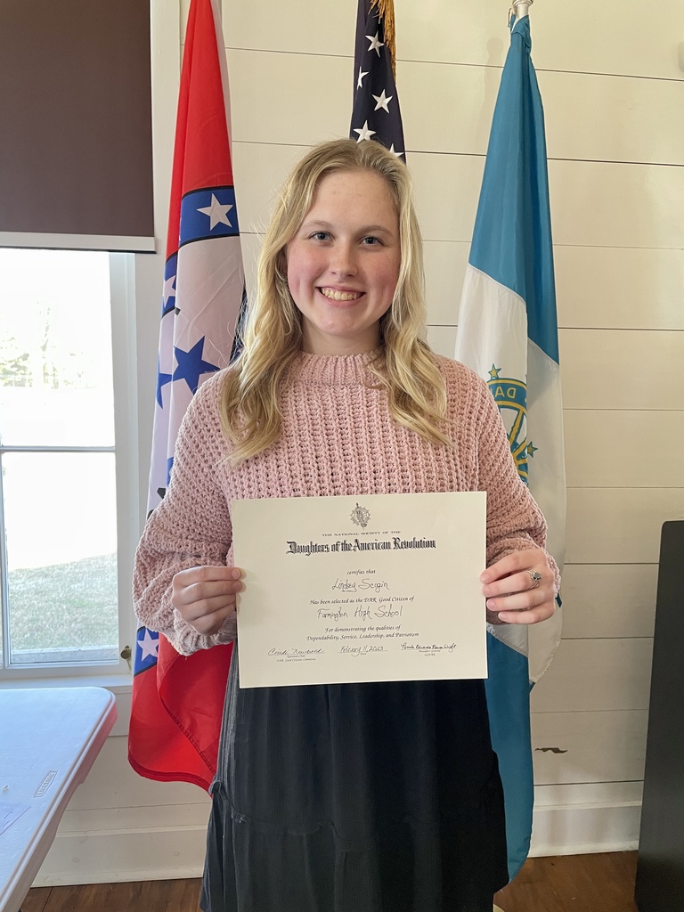 student posing with certificate
