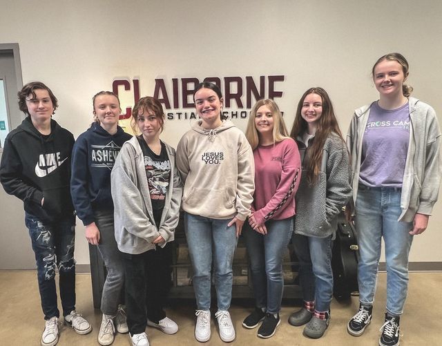 seven students standing for group photo smiling
