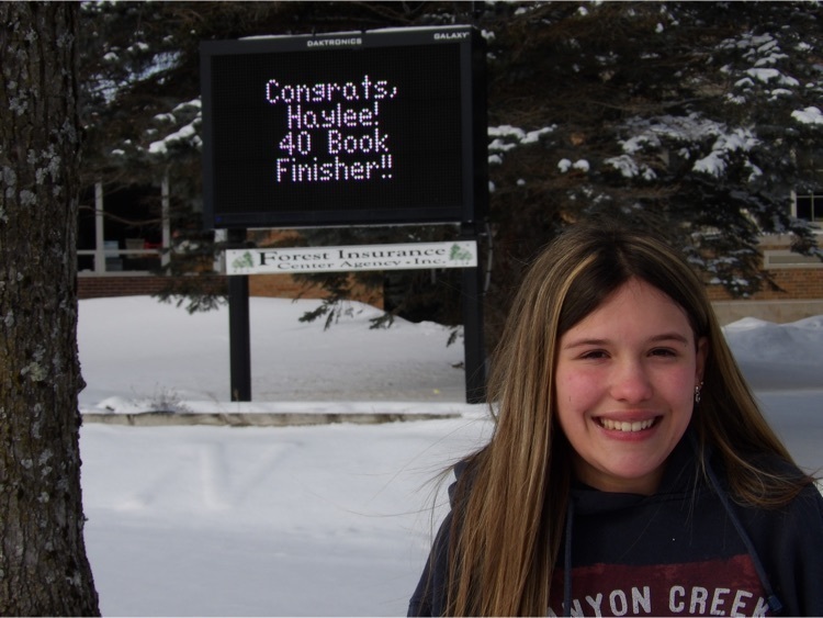 child in front of marquee