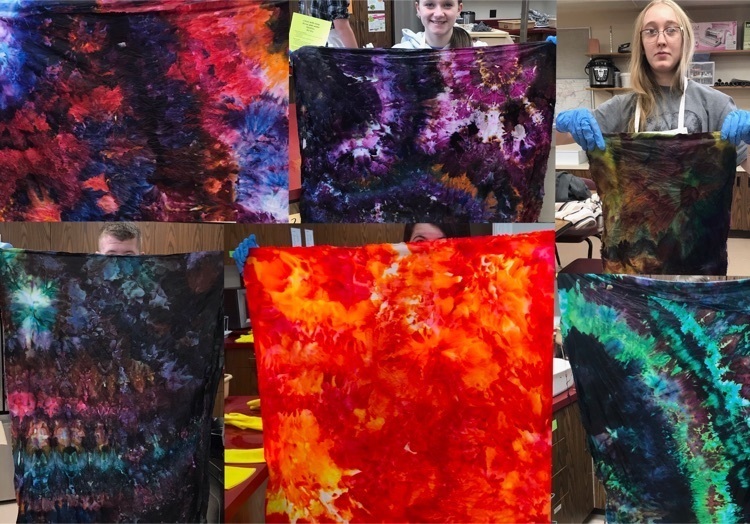 students holding up dyed fabric