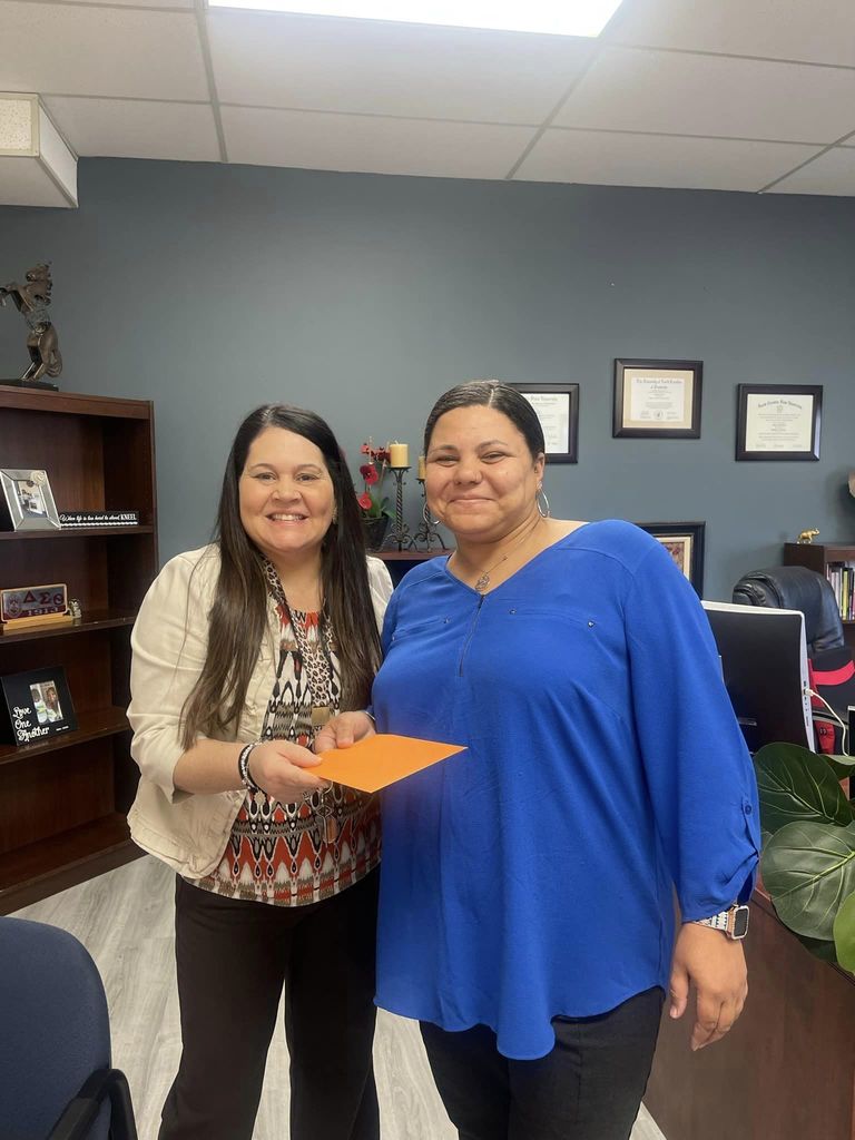 Two women smiling in counselor's office