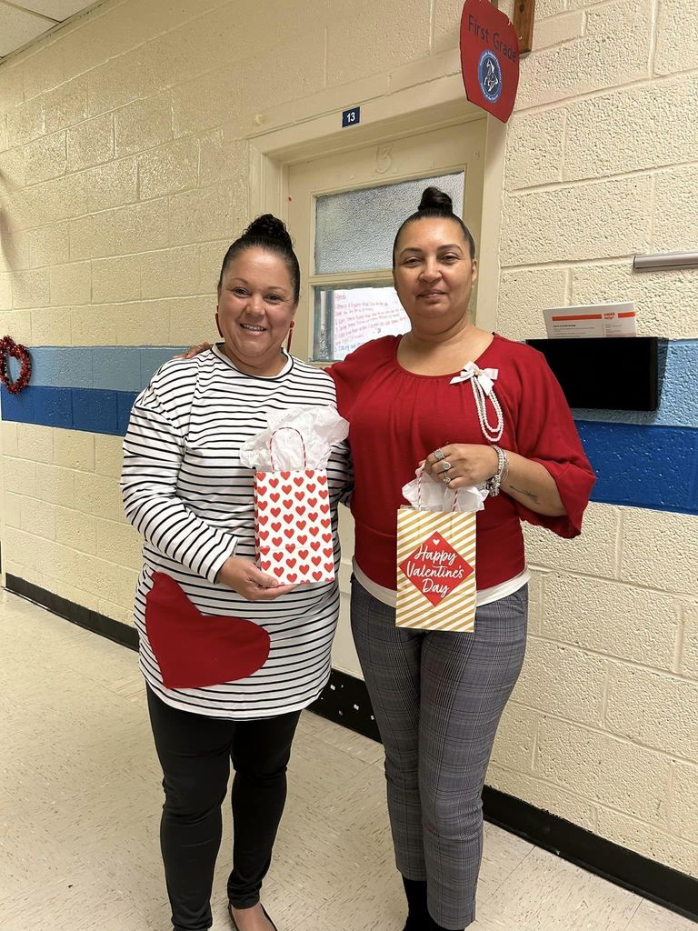 Two women smiling in school hallway