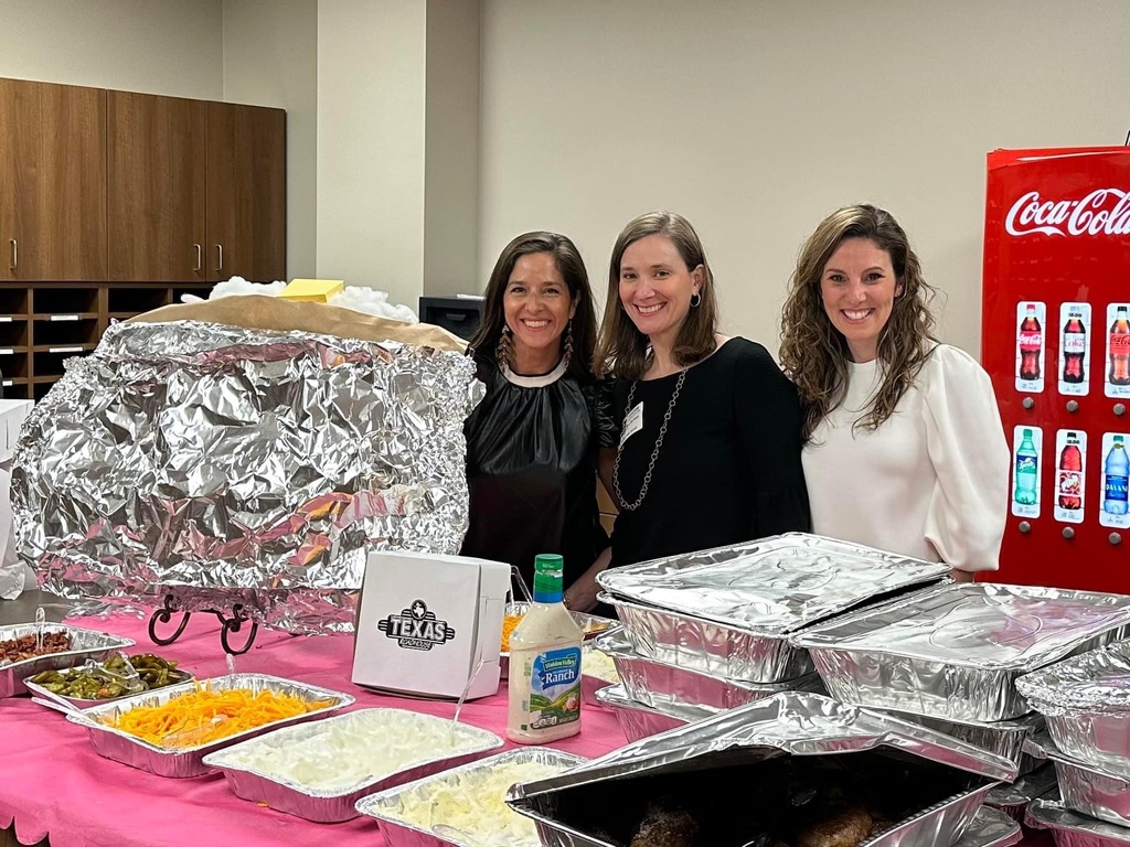 Members of Legacy PTA posing with the Texas Roadhouse lunch they treated staff with today