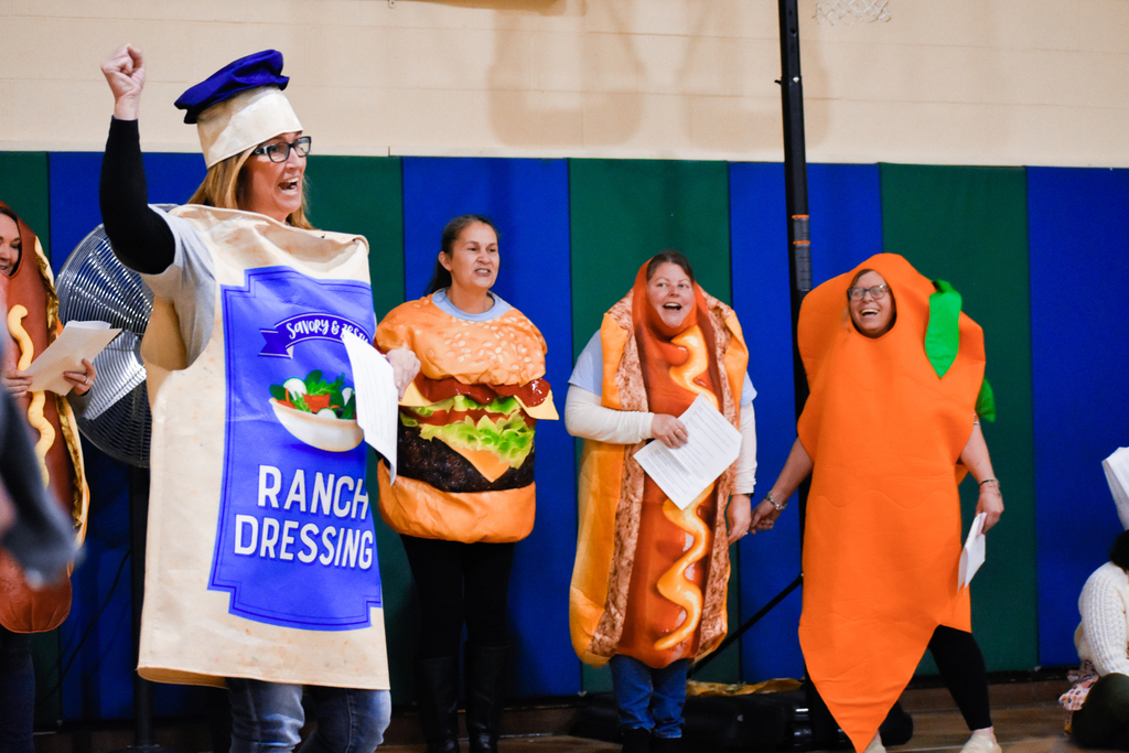 teachers dressed as ranch dressing, a burger, a hot dog, and a carrot