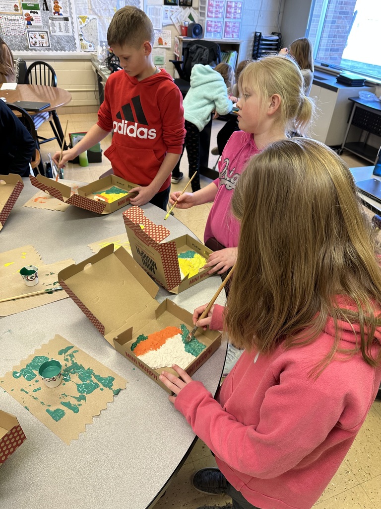 Students paint their Wisconsin landform region models made out of salt dough