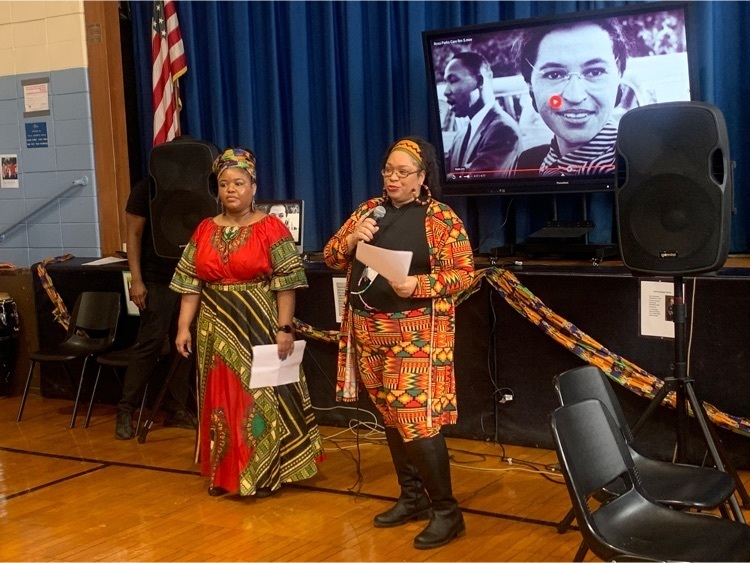 staff members dressed in African clothing present to the school