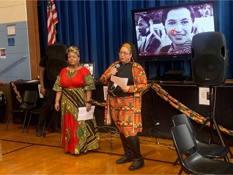 staff members dressed in African clothing present to the school 