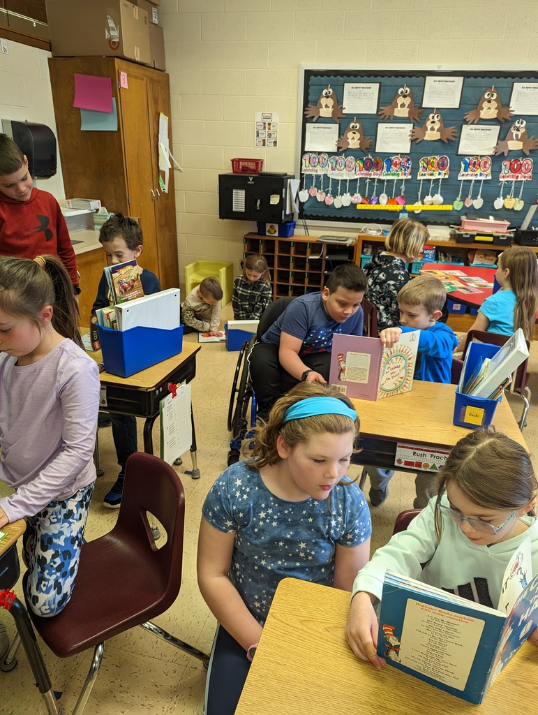 4th grade students sit near 1st grade students in their classrooms and read