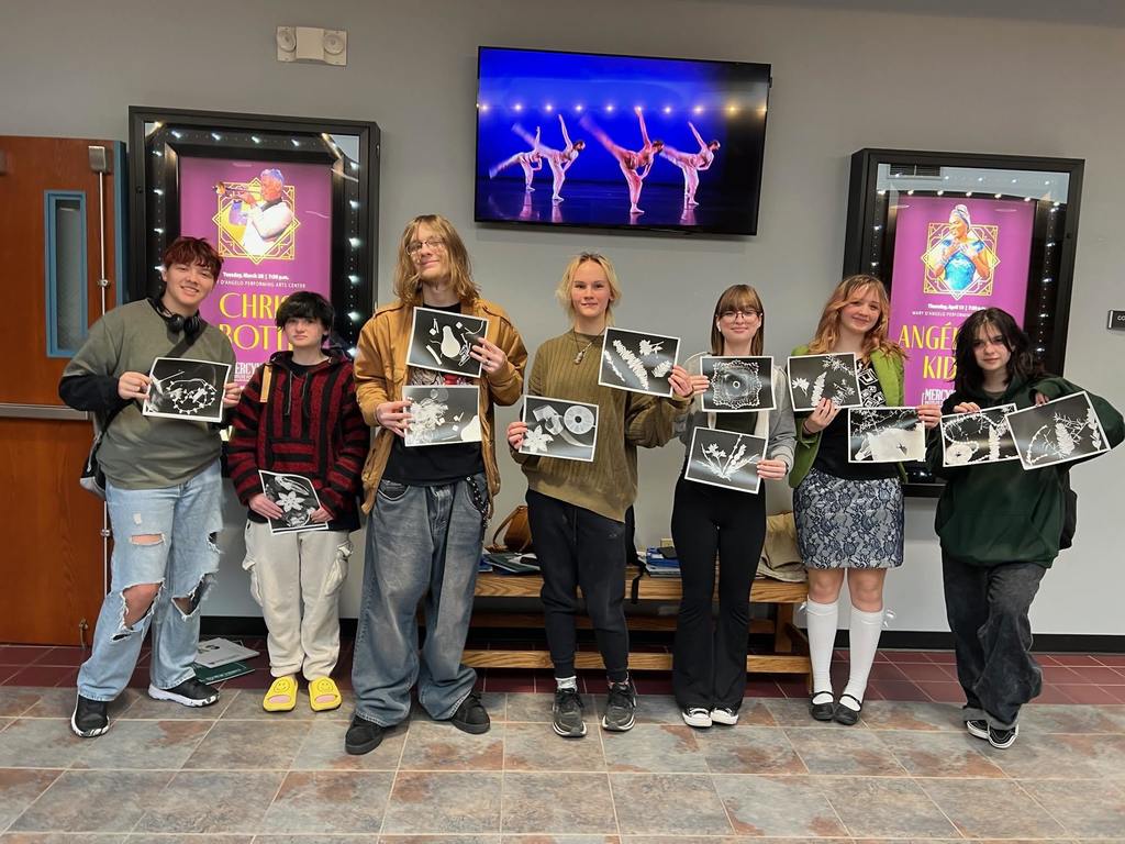 Students posing with their art