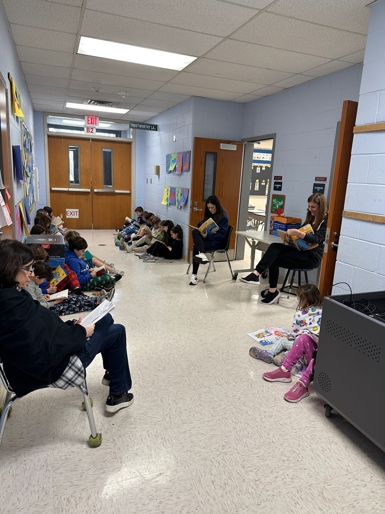 Wilson second graders sitting in the hallway, reading
