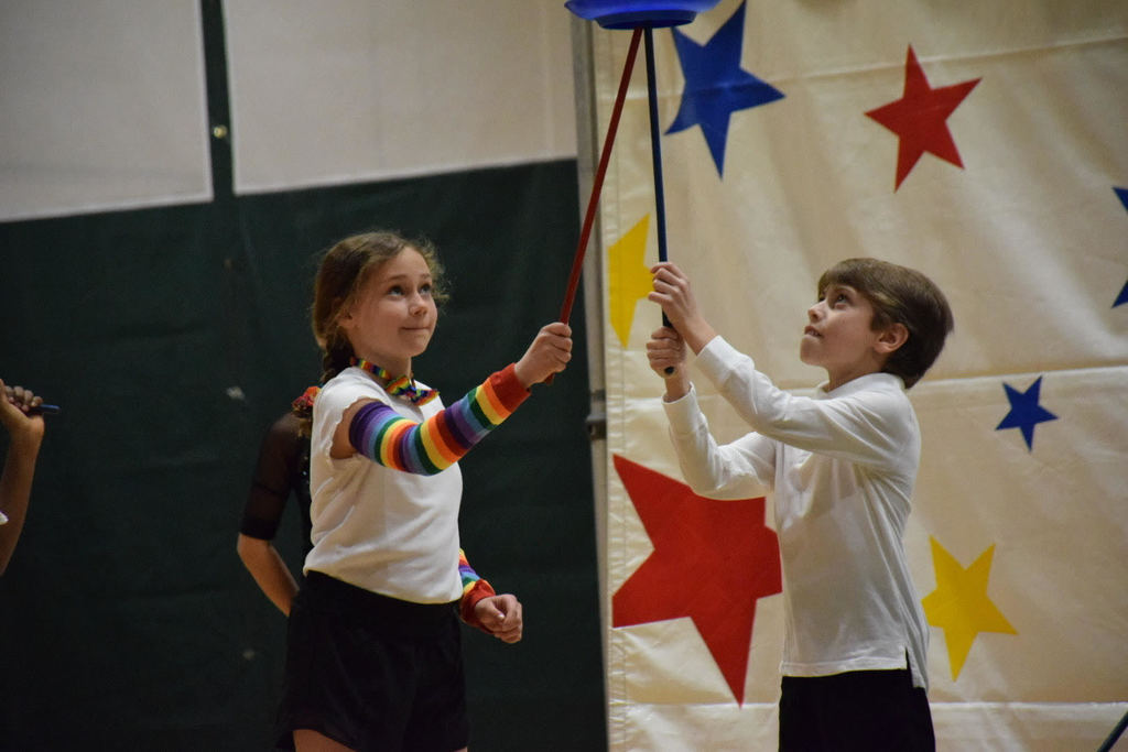 Charley London (left) passes Jason Eisenberg a spinning plate.