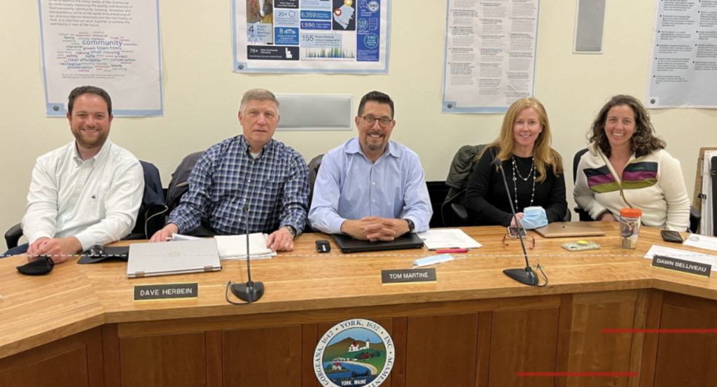 A photo of York School Committee's five members waiting for a meeting to begin.
