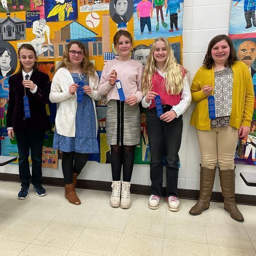 students holding ribbon