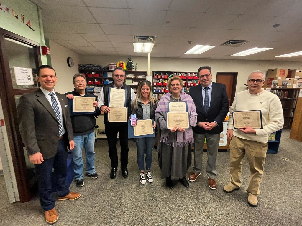 Staff members taking a picture with their certificates