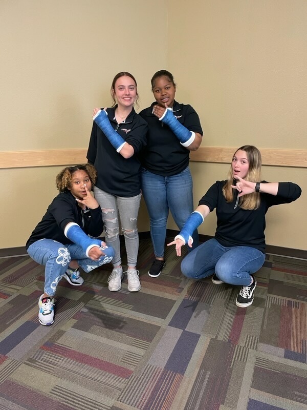 Legacy Athletic Trainers posing with their casts
