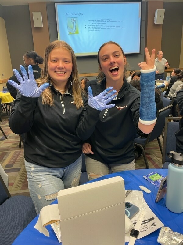 Legacy athletic trainers learning how to cast a broken bone