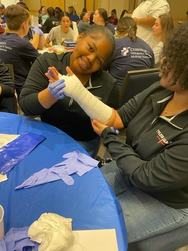Legacy athletic trainers learning how to cast a broken bone