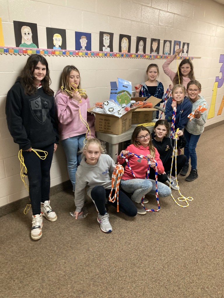 Girls standing by supplies.