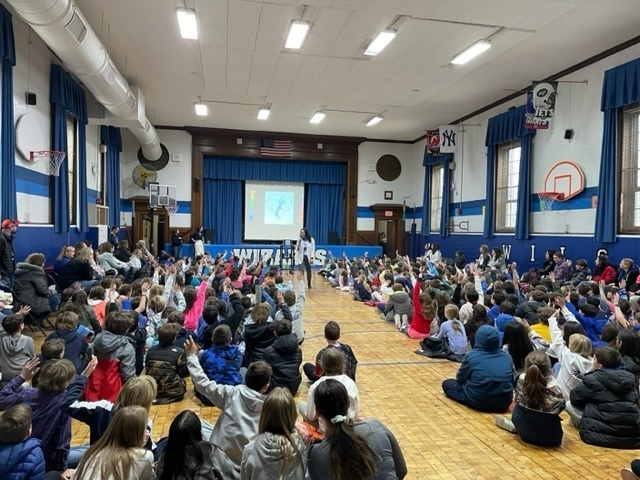 Wilson student body raising their hands to share during the neurodiversity week wrap up assembly